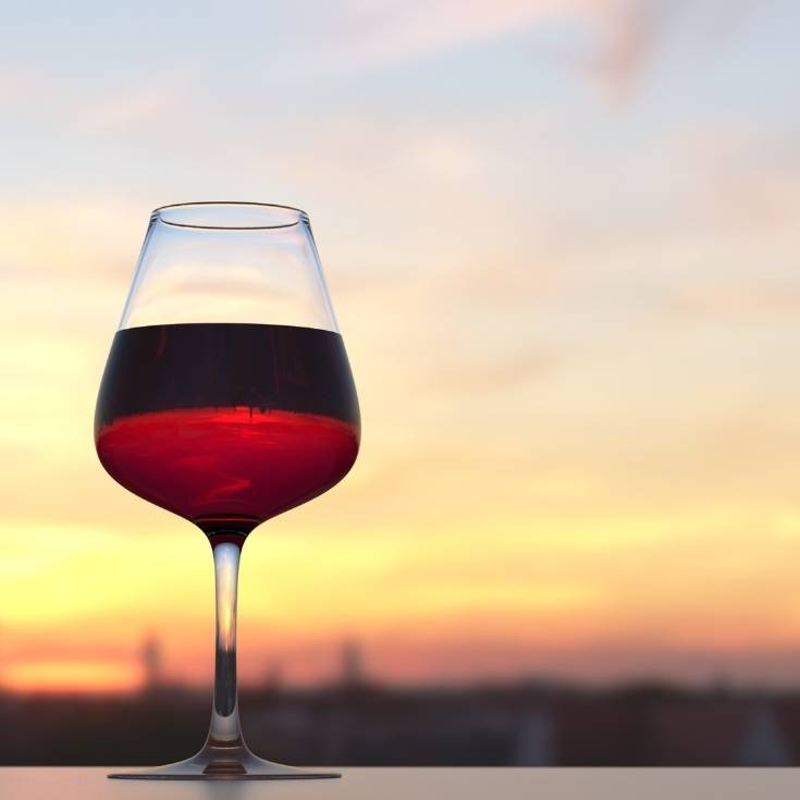 red wine in a glass at sunset