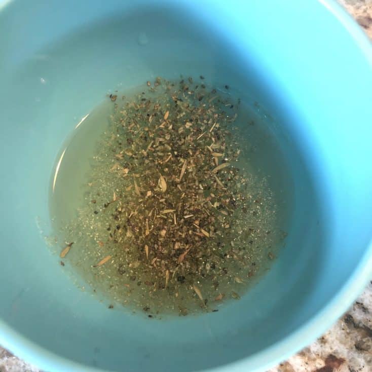 oil and spices in a measuring cup