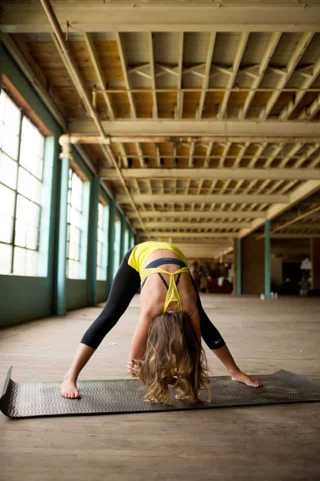 Kalee doing wide leg forward fold yoga move