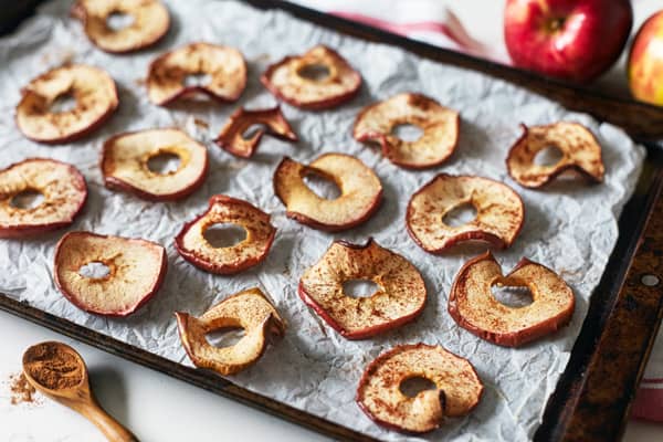 baked apple chips on a baking sheet