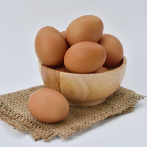 brown eggs in a wooden bowl