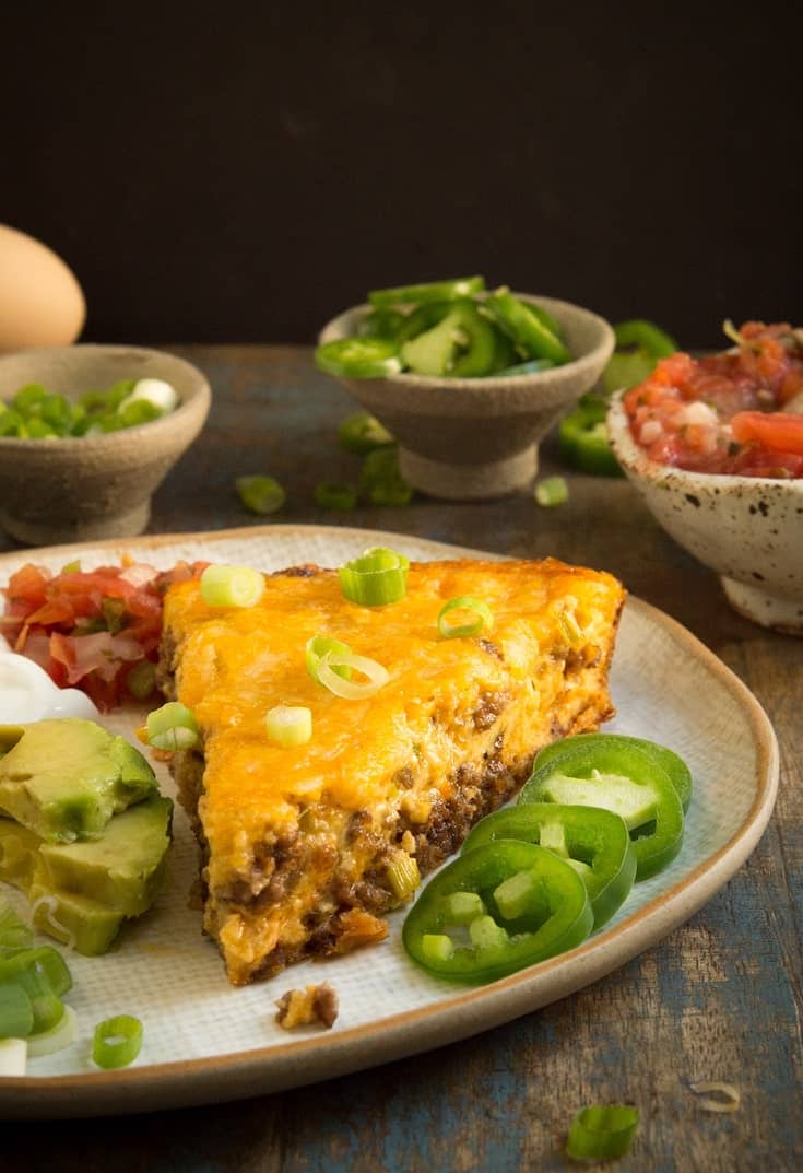 Crustless taco pie with jalapeños, avocado and salsa is one of our favorite keto ground beef recipes