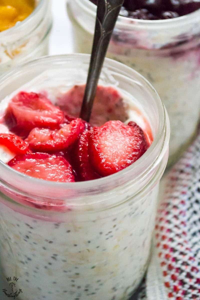 sliced strawberries on overnight oats with chia seeds