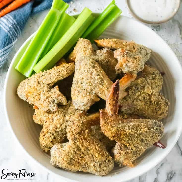 keto chicken wings in a bowl with celery