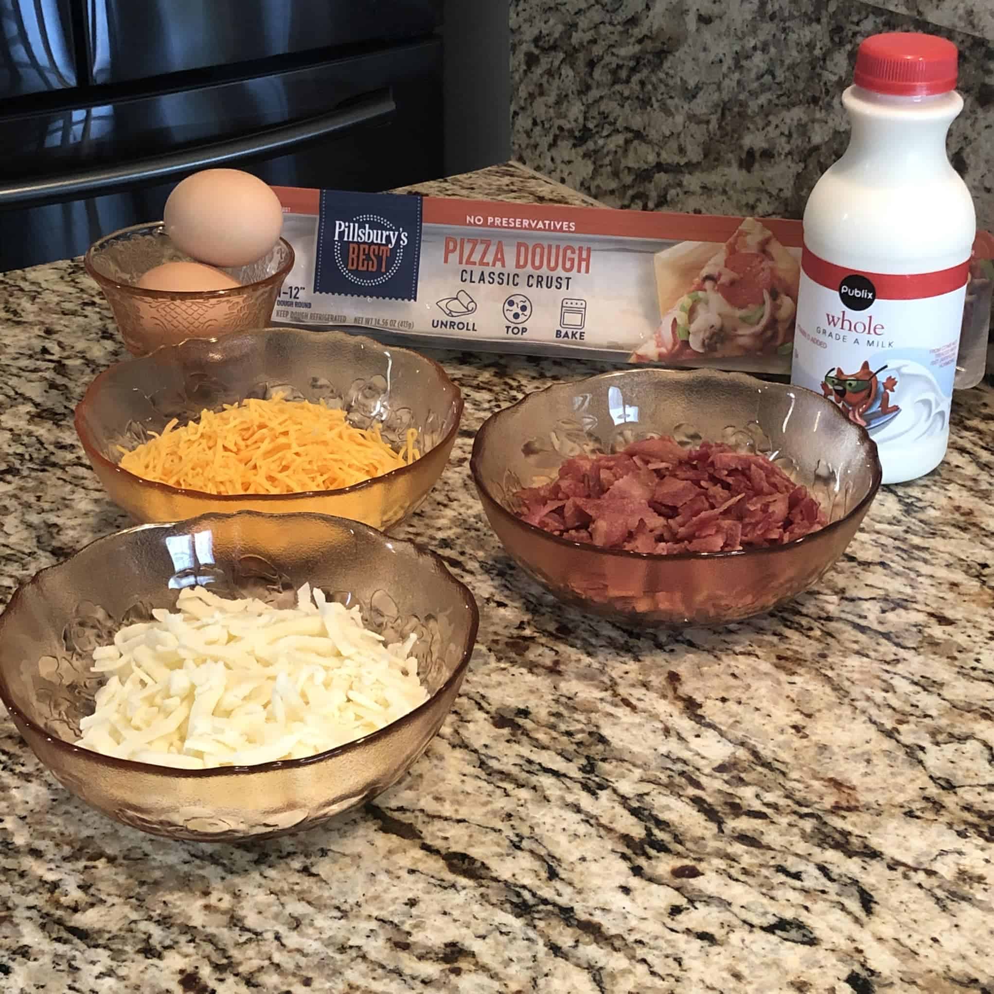 Pizza ingredients include bacon, cheese, eggs, pizza dough and milk
