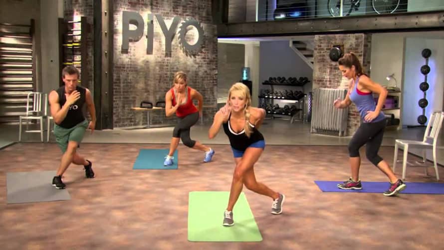 Chalene and cast in a bowlers lunge during a piyo workout