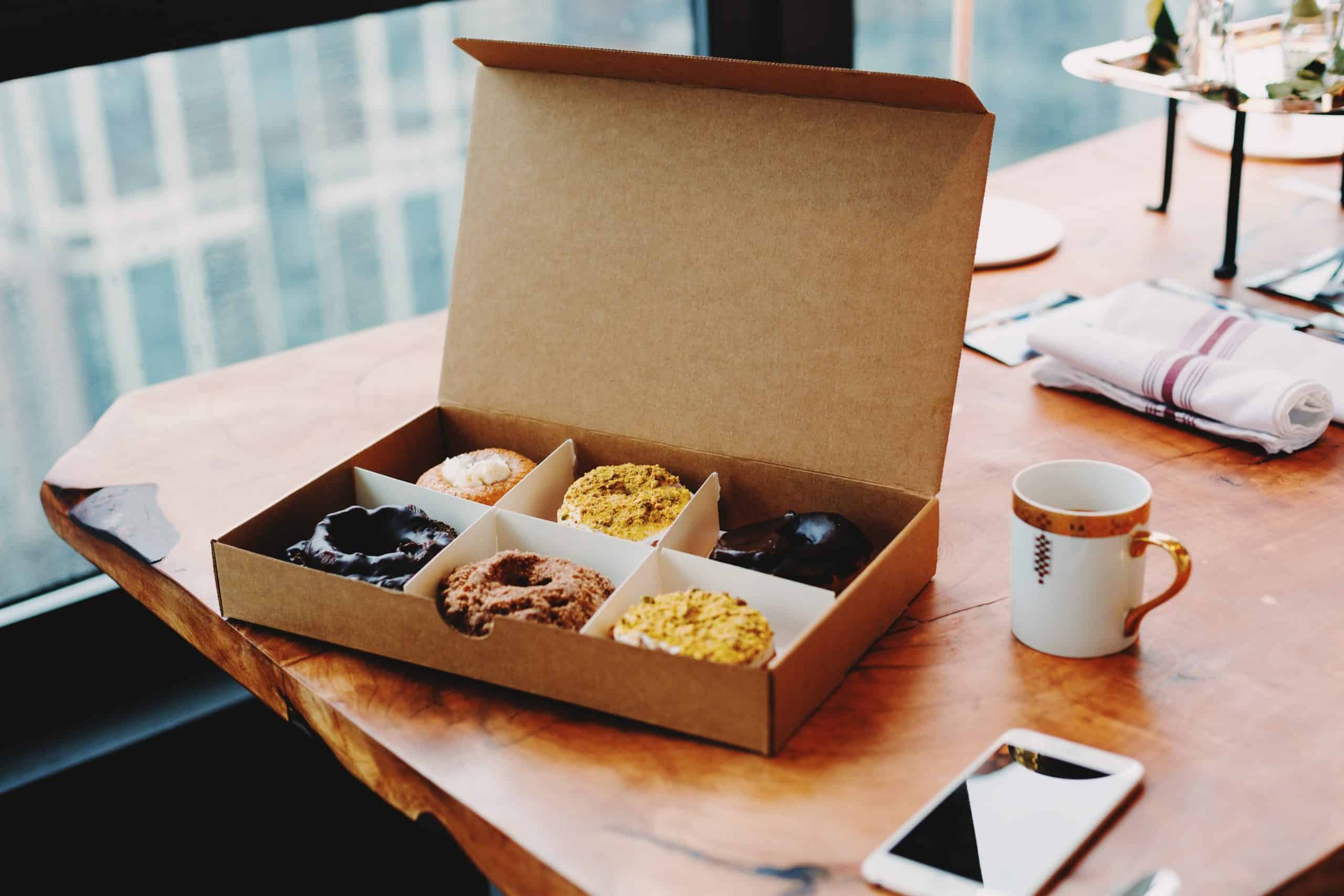 Box of donuts sitting on a desk