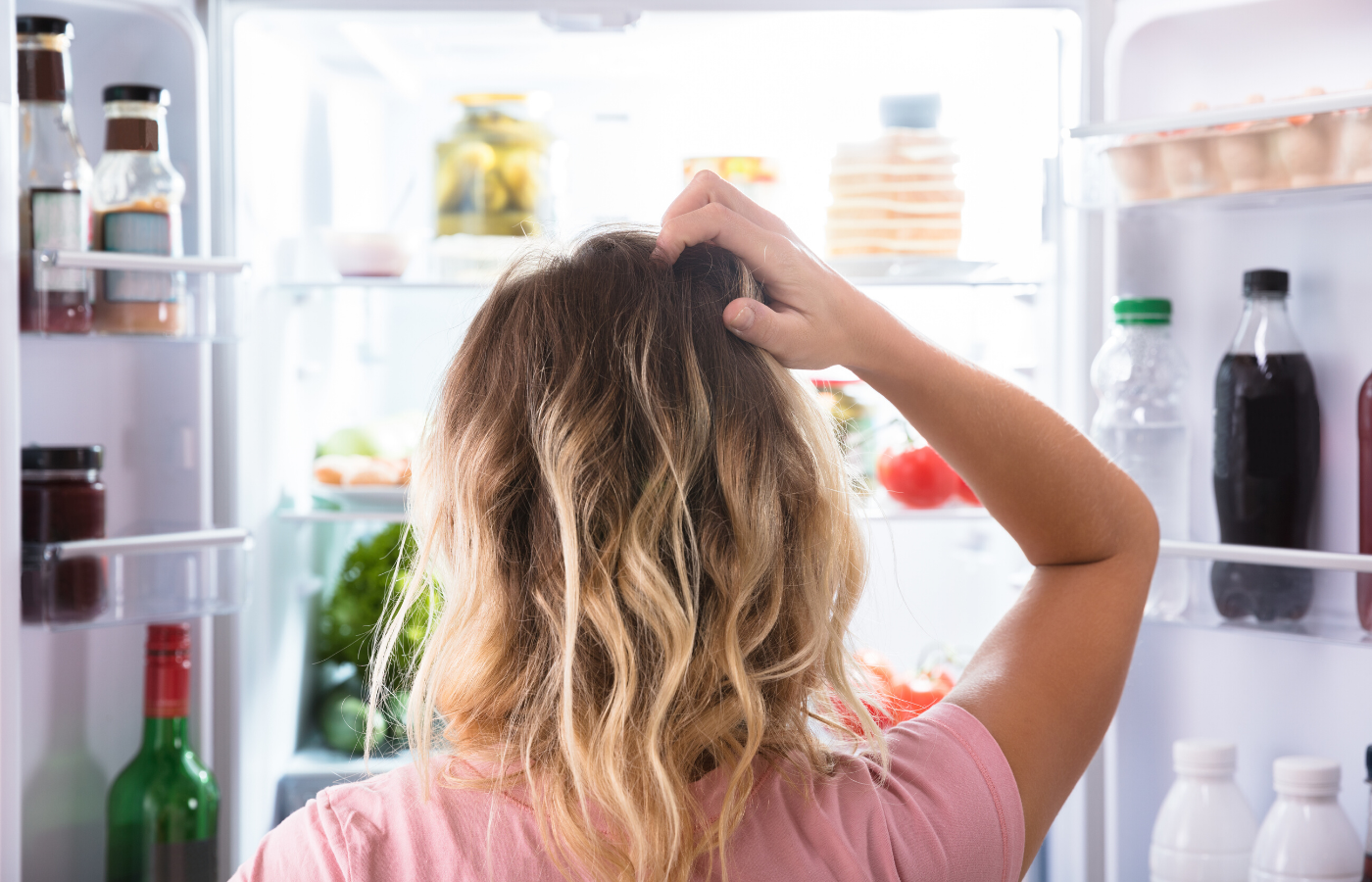 woman confused at the fridge