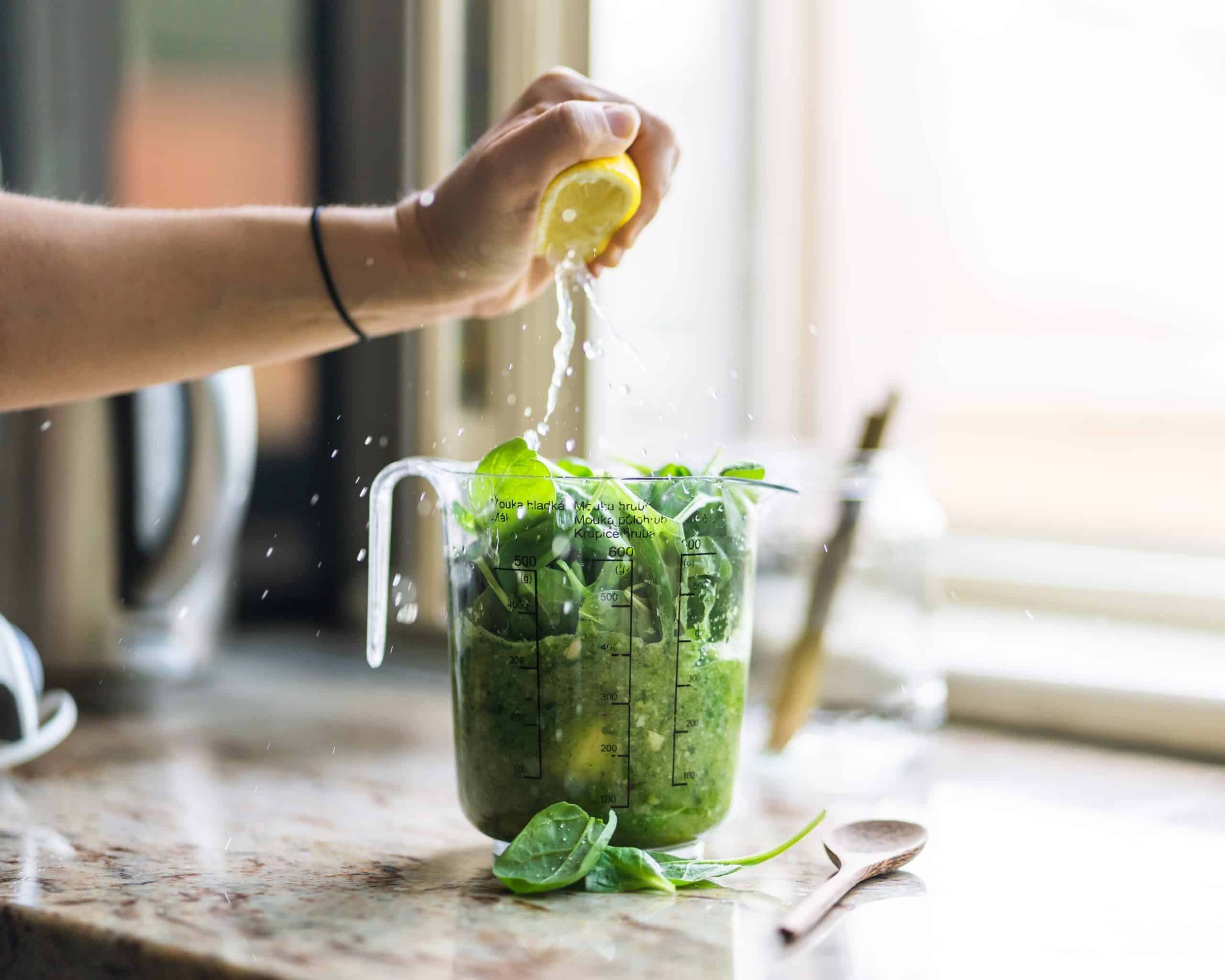 measuring bowl with green smoothie ingredients