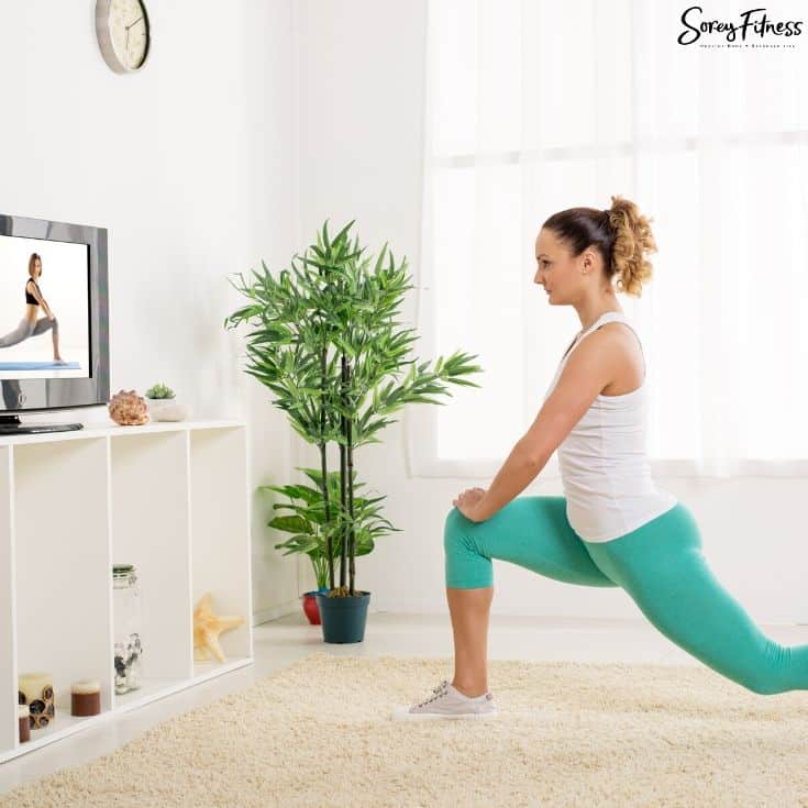 woman exercising to an openfit workout