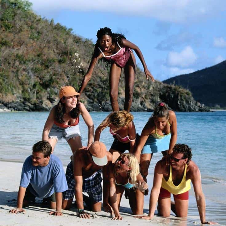 people doing a pyramid on a beach