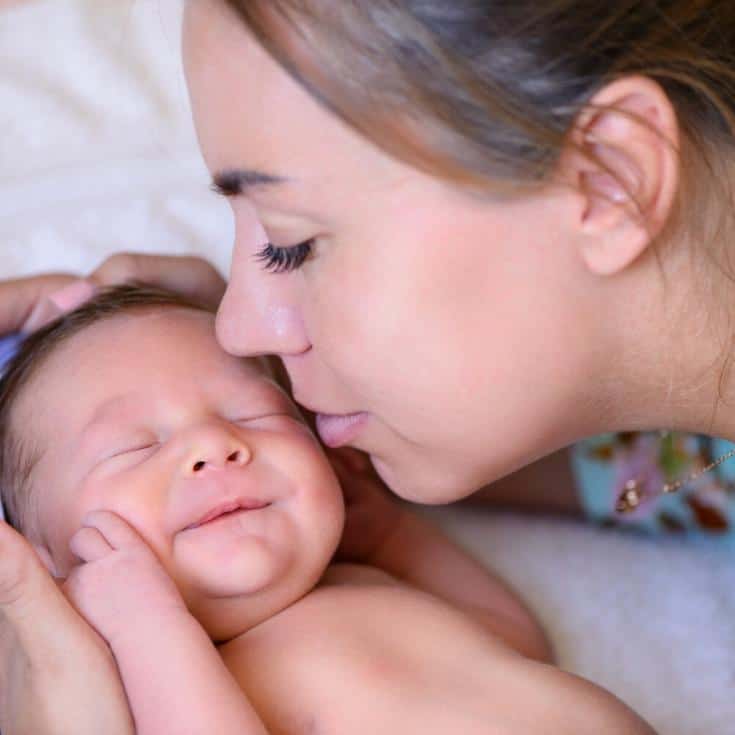 mother kissing baby