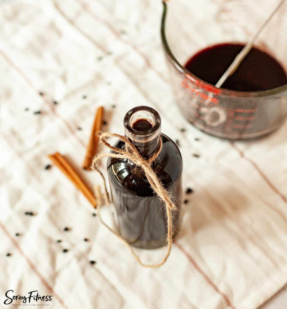 Bottle of elderberry syrup with a string tied on it