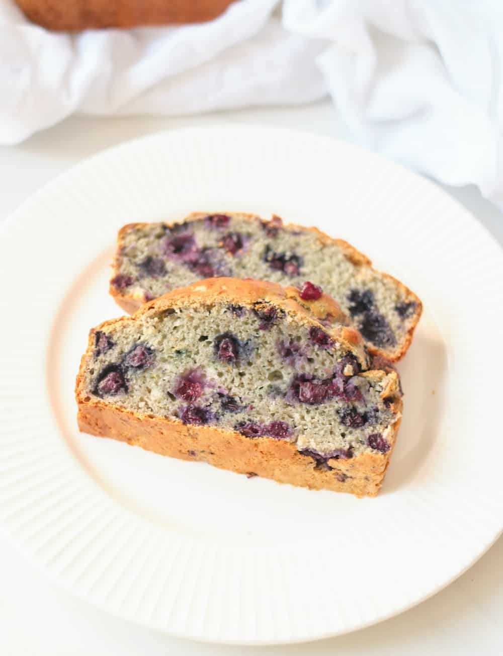 2 slices of protein blueberry bread on a plate