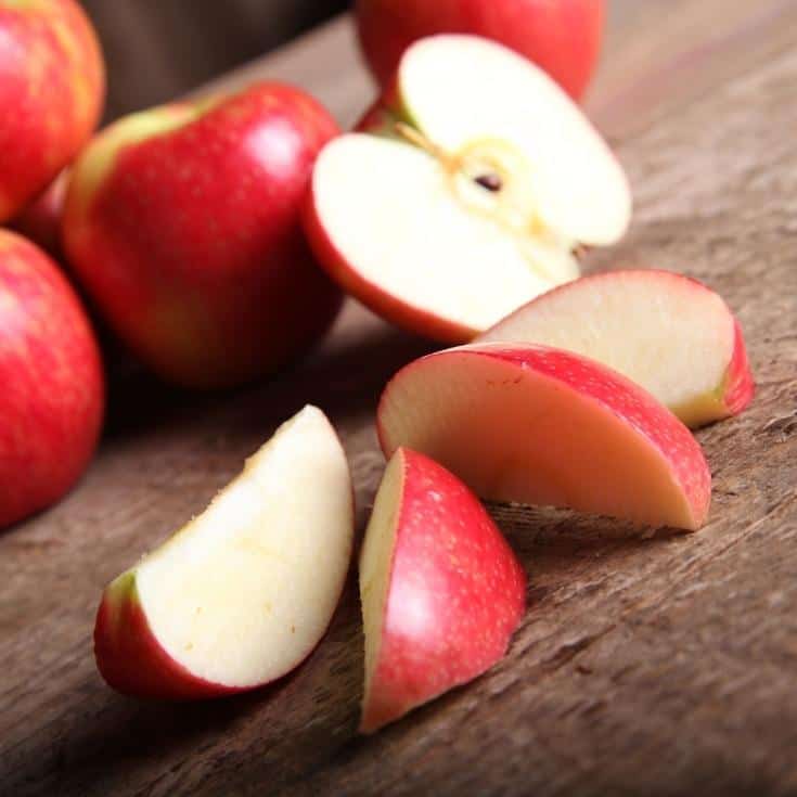 cut up apples on a wooden board