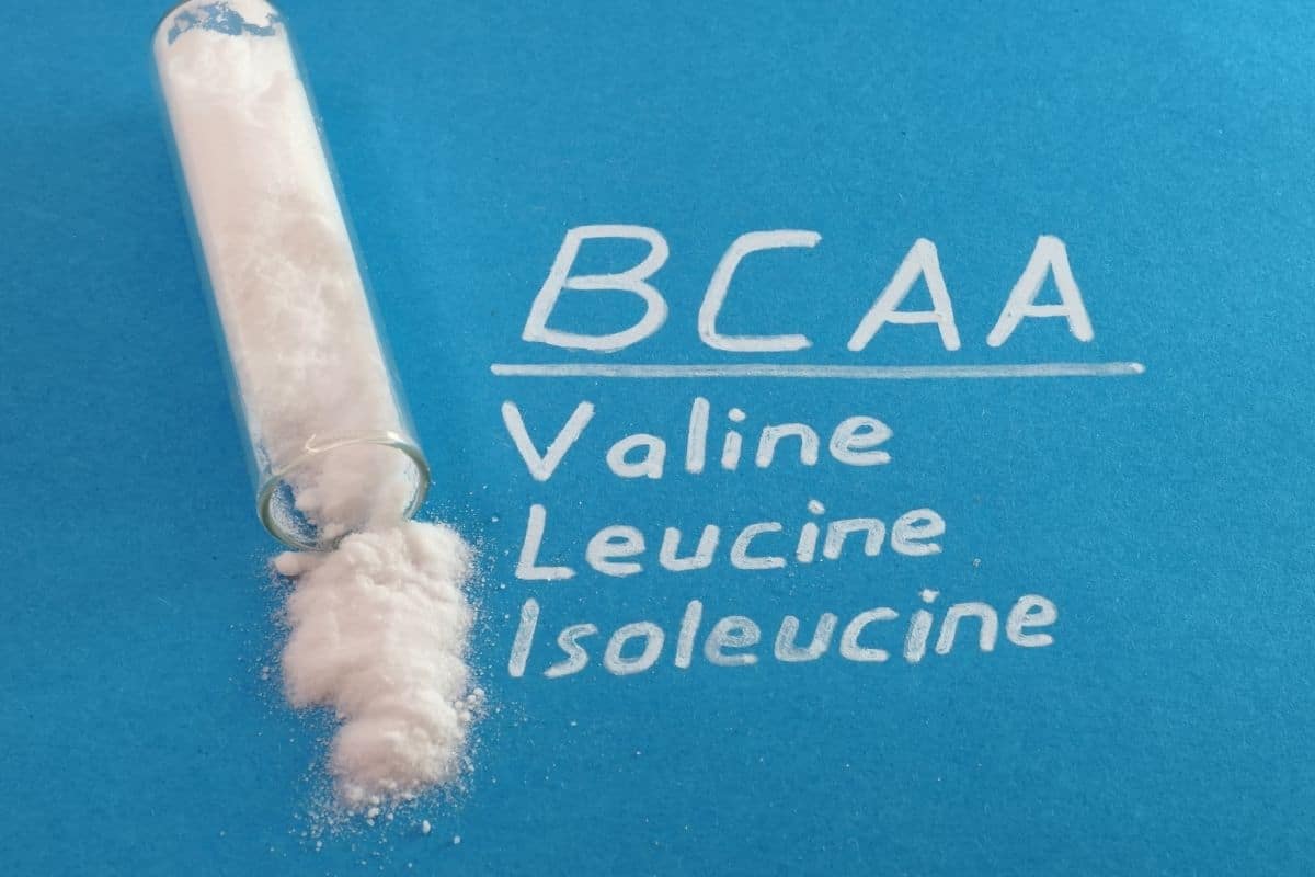 BCAA Valine Leucine Isoleucine written next to the powder form of BCAA