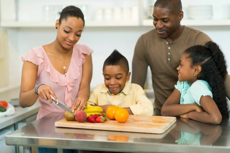 family prepping fresh fruit together