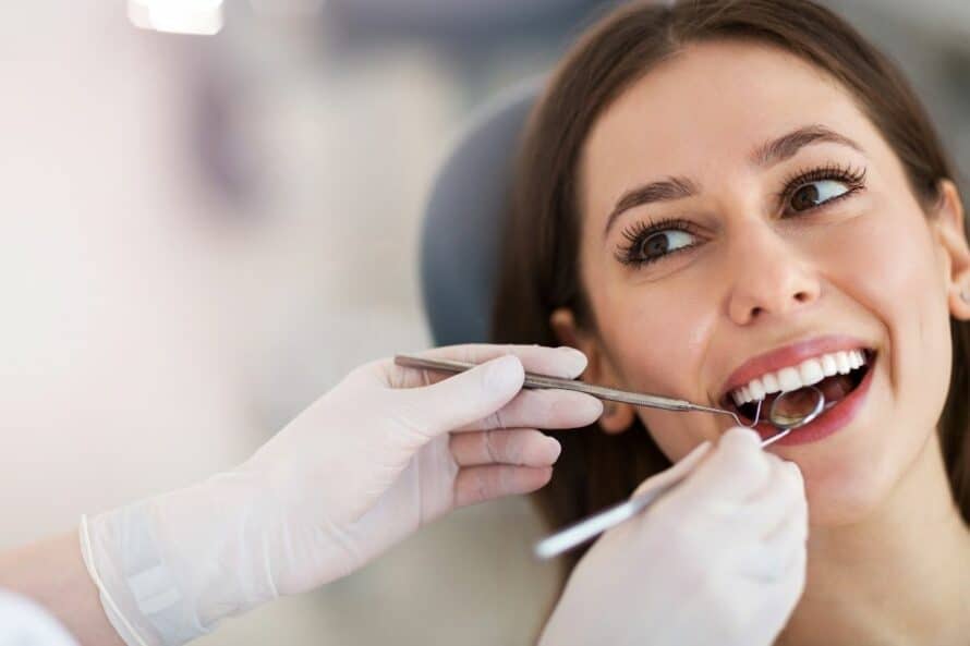 woman in having her teeth looked at by an oral surgeon