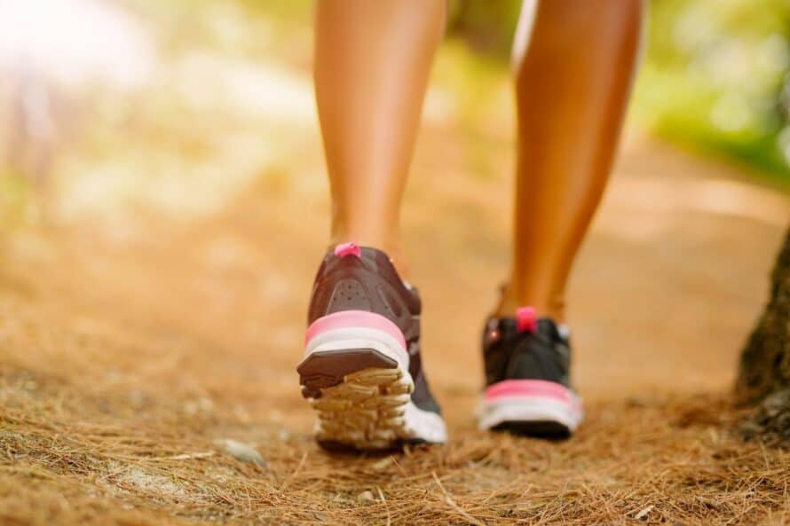 woman in tennis shoes on a trail