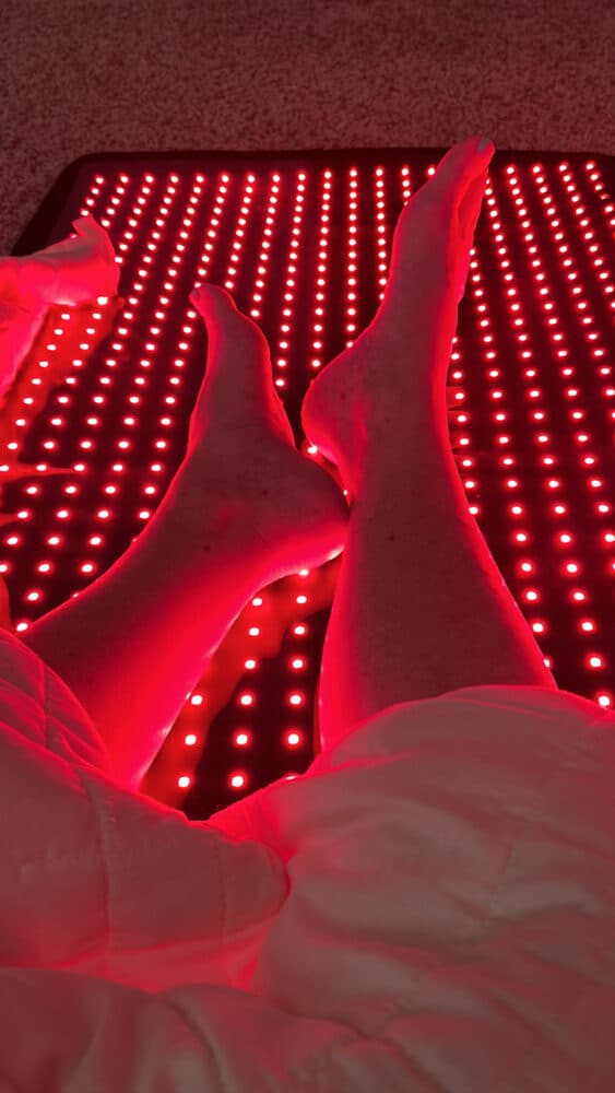 calves and feet on top of the mito red light therapy mat