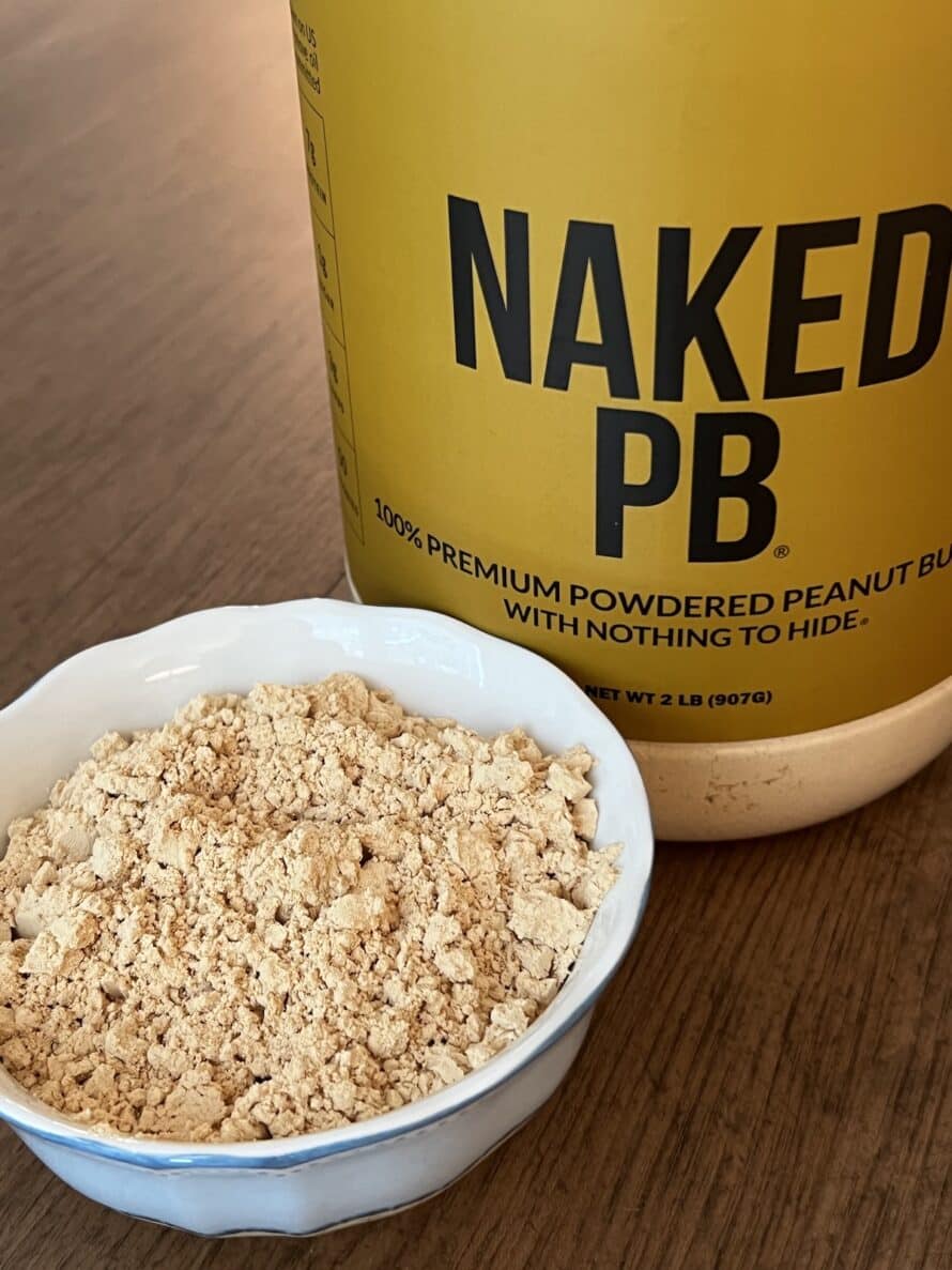 Naked PB tub and the peanut butter powder in a small bowl to show consistency