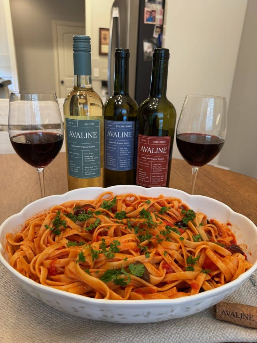 Variety of Avaline wines with a dish of pasta and 2 glasses of wine poured