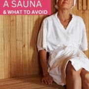 woman in a robe and towel on her head in a sauna - text overlay says what to wear in a sauna & what to avoid