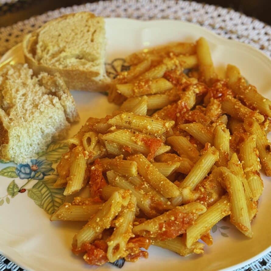 creamy ricotta pasta on a plate with bread