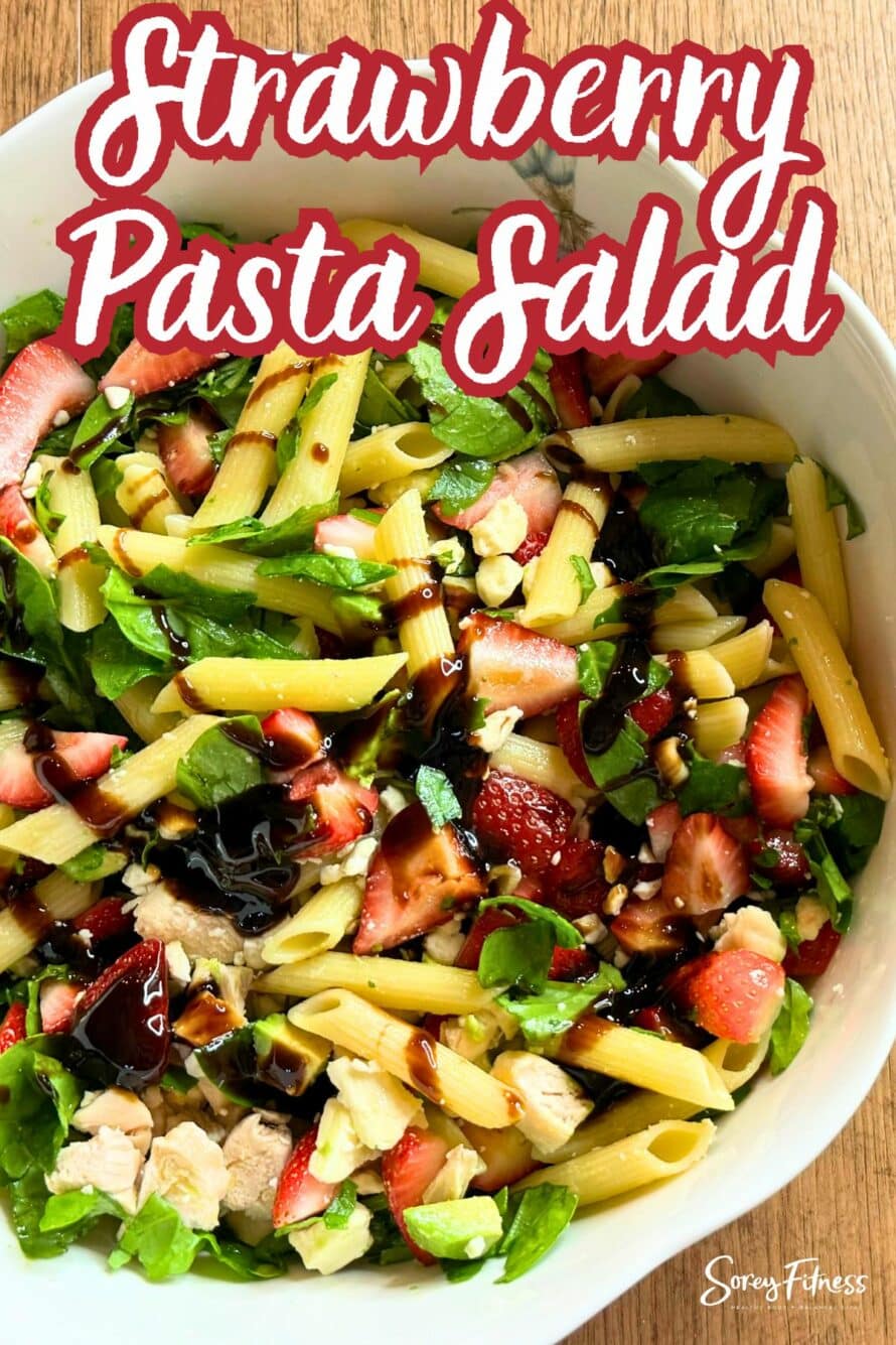 close up of the recipe in a bowl - text overlay says strawberry pasta salad