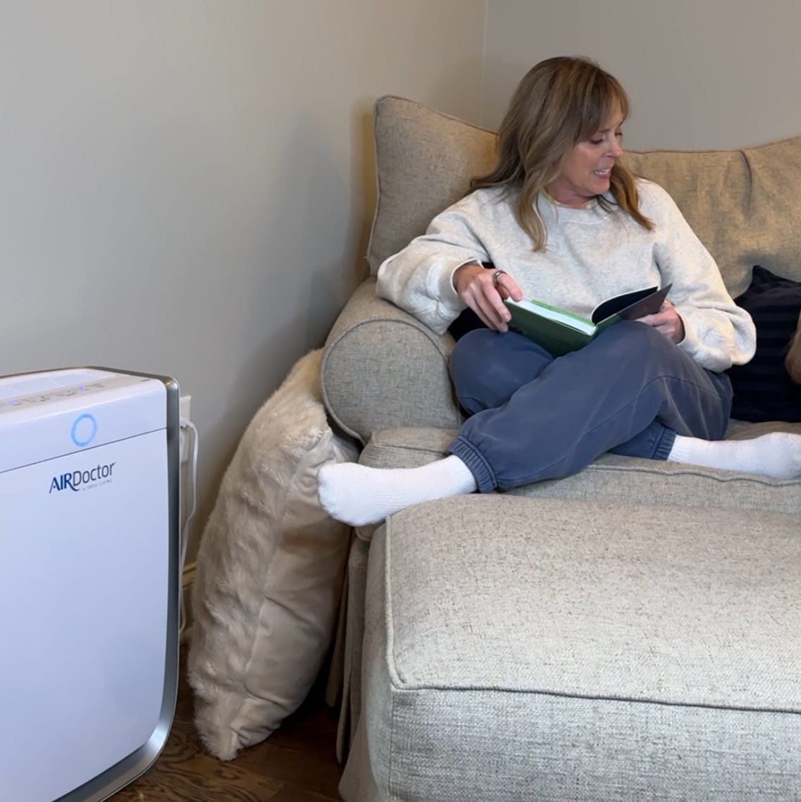 Kim sitting beside the airdoctor 3500i