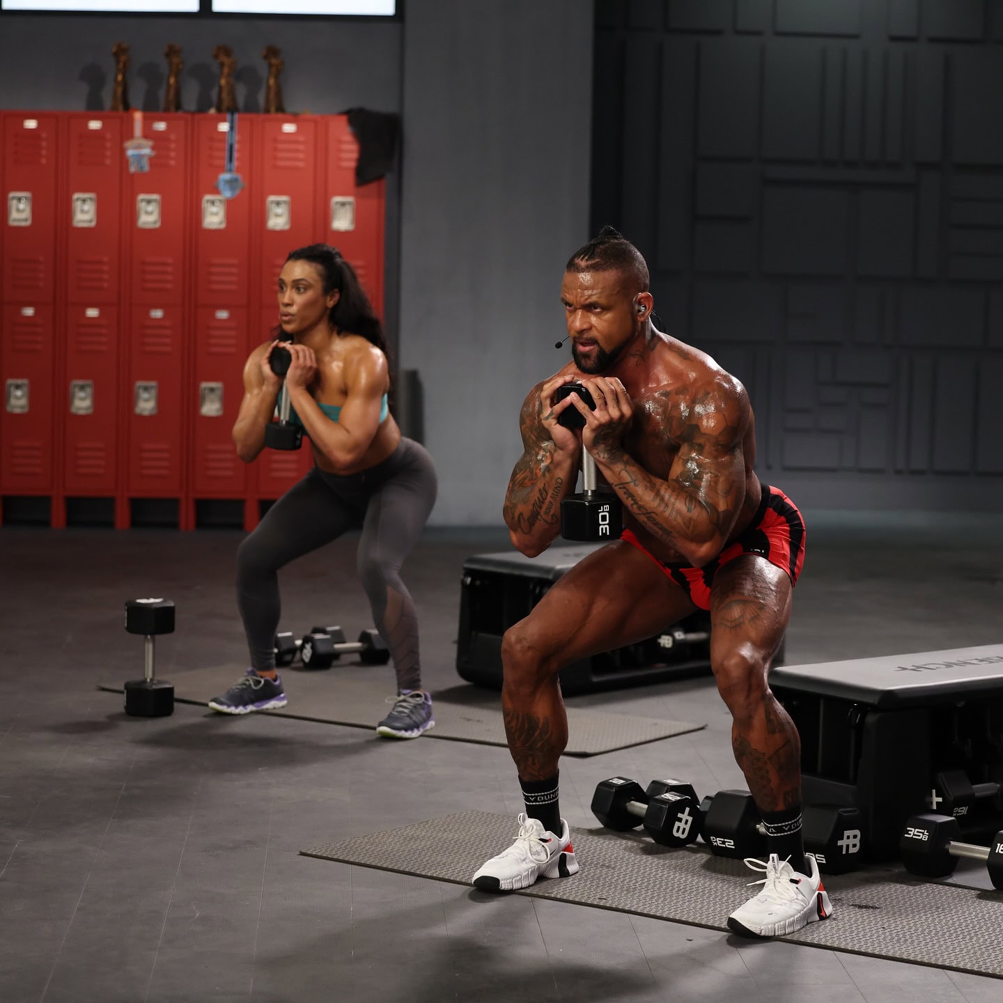 shaun t in dig in workouts doing a squat